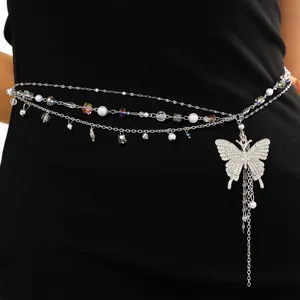 Detailed macro view of multi-layer waist chain with rhinestone butterfly and pearls