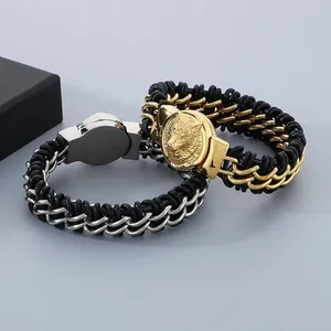Detail shot of men's leather woven bracelets with gold lion and silver wolf heads