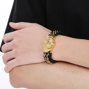 Close-up view of a men's braided leather bracelet featuring a stylish golden lion head
