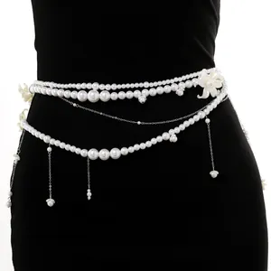 Detailed view of white multi-layer pearl waist chain with elegant floral shell charms