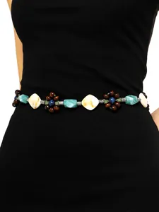 Close-up of bohemian beaded waist chain with turquoise and wood flower accents