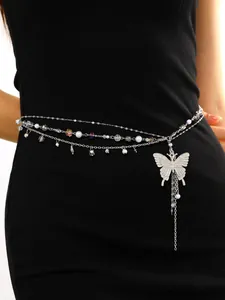 Detailed view of silver layered waist chain with large butterfly pendant and pearls.