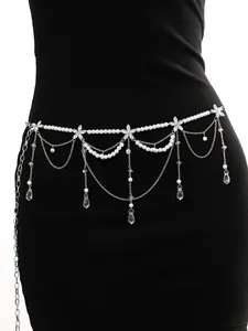 Detail view of a multi-layer pearl waist chain with fringe tassels on a black dress.