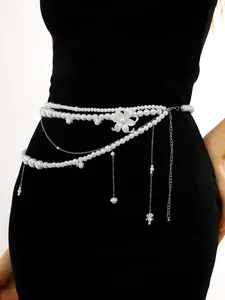 Detailed view of elegant multi-layer pearl waist chain with shell pendant and tassels
