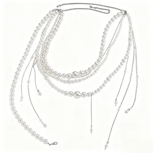 Detailed view of layered white pearl waist chain with fringe tassels for dresses