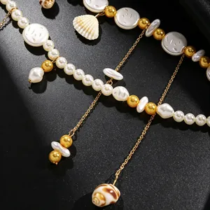 Detailed macro shot showing the seashell and pearl textures on a layered waist chain