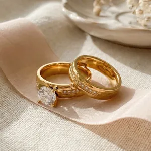 Elegant gold-plated stainless steel couple ring set with sparkling CZ stones for wedding.