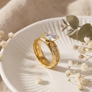 Macro detail of a gold textured stainless steel ring featuring a large CZ center stone