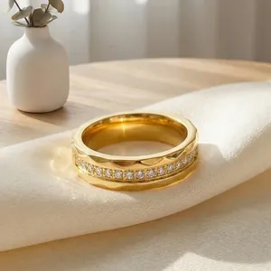 Macro shot of gold stainless steel ring featuring hammered texture and crystal inlay