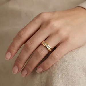 Elegant gold-plated stainless steel ring with pavé-set sparkling crystals shown on hand