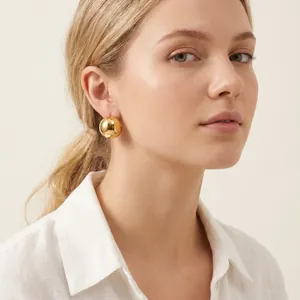 Elegant modern gold stainless steel chunky dome earrings for women shown on model