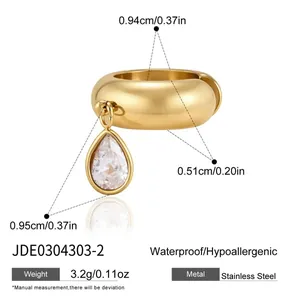 Macro detail of 18k gold plated stainless steel earring with teardrop zircon pendant