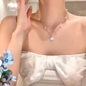 Close-up of elegant zircon flower pearl necklace worn by a model in French style