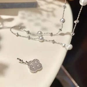 Elegant French style zircon flower pendant pearl necklace with a refined silver finish
