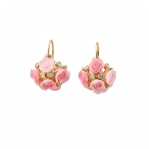 Elegant gold hoop earrings featuring pink resin rose clusters and sparkling crystals.