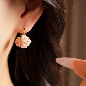 Detailed view of elegant pink resin rose flower hoop earrings with sparkling rhinestones
