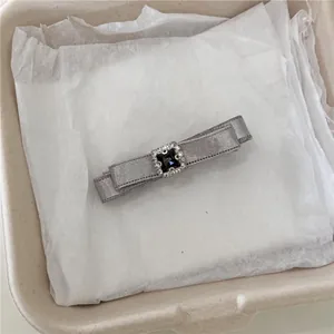 Elegant gray satin ribbon hair clip with a square black rhinestone center piece
