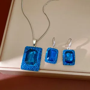 Detailed shot of a geometric blue rhinestone jewelry set with necklace and earrings