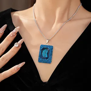 Close-up of elegant square blue gemstone necklace with rhinestone detailing on neck