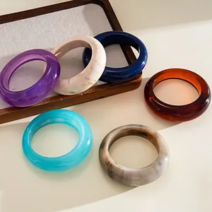 Collection of colorful marble-effect resin bangles in vintage geometric designs for women