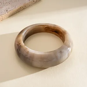 Close-up of retro resin bangle featuring a brown marble ink-wash texture