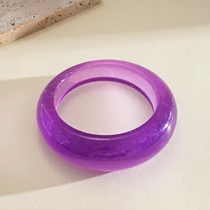 Close-up detail of a minimalist purple resin bangle with fine glitter shimmer finish
