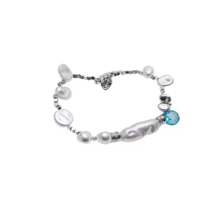 Baroque pearl bracelet featuring irregular pearls and a blue faceted gemstone drop charm