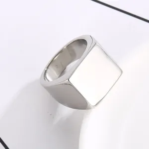 Detailed close-up of polished silver stainless steel signet ring with flat square face