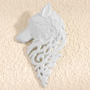 Close-up detail of a white vintage wolf head lapel pin with intricate scrollwork