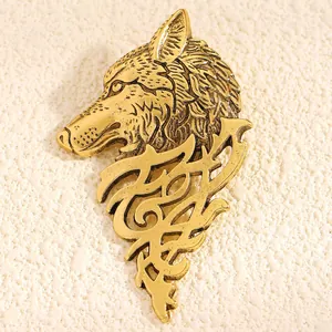 Detailed macro view showing the intricate textures of a vintage golden wolf head brooch
