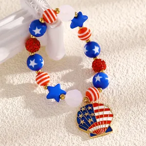 Detail view of US Independence Day beaded bracelet with stars and flag shell pendant