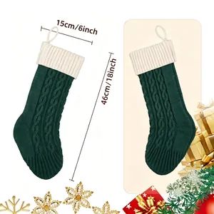 Green cable knit Christmas stockings with cream cuff and precise size markings 15x46cm
