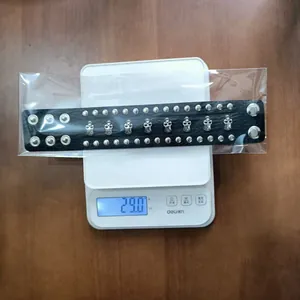 Handmade punk style wide black leather bracelet with metal skulls weighing 29.0 grams