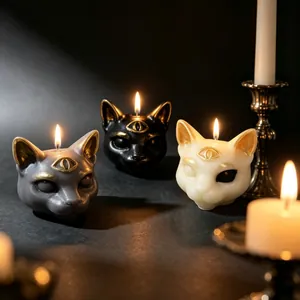 Mystical three-eyed cat head candles in black, white, and gray for Halloween decor