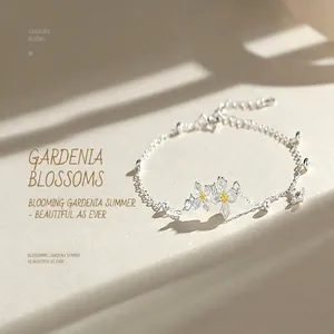 Detailed macro view of S925 silver bracelet featuring zircon gardenia flowers.
