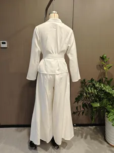 Back view of elegant white long-sleeve blazer and wide-leg pants set on mannequin