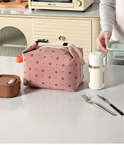 Pink floral corduroy insulated lunch bag shown in a lifestyle kitchen scene with props