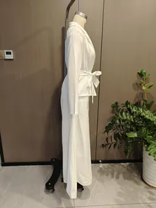 Side view of a fashionable white long-sleeve belted top and wide-leg trousers set