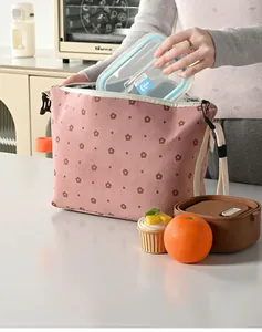 Close-up view of pink corduroy floral lunch bag with insulated aluminum foil lining