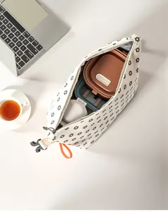 Spacious corduroy floral lunch bag with bento box and bottle inside on office desk