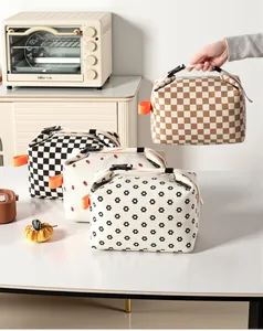 Assorted corduroy insulated lunch bags with checker and floral prints in a kitchen
