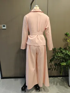Rear view detail of a pink two-piece set with belted top and wide-leg trousers.