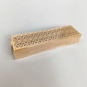 Detailed view of laser-cut golden napkin rings stacked in clear protective plastic wrap