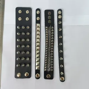 Close-up detail of four punk spiked leather bracelets in a rock style DIY jewelry set