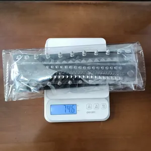 Close-up of 4pcs punk spiked leather bracelet set on a scale showing 74.6g weight.