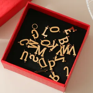 Gold 316L stainless steel uppercase letter charms for DIY jewelry in a red gift box