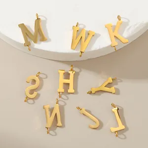 Close-up of gold-plated 316L stainless steel uppercase letter charms for DIY jewelry.