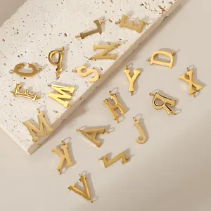 Detailed view of gold 316L stainless steel uppercase alphabet charms with double holes.