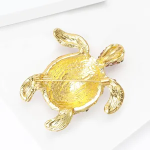 Golden alloy turtle brooch pin with rhinestone details, back view showing secure pin clasp.