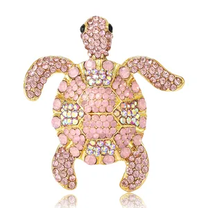 Sparkling turtle brooch with pink and iridescent rhinestones on a gold alloy base.
